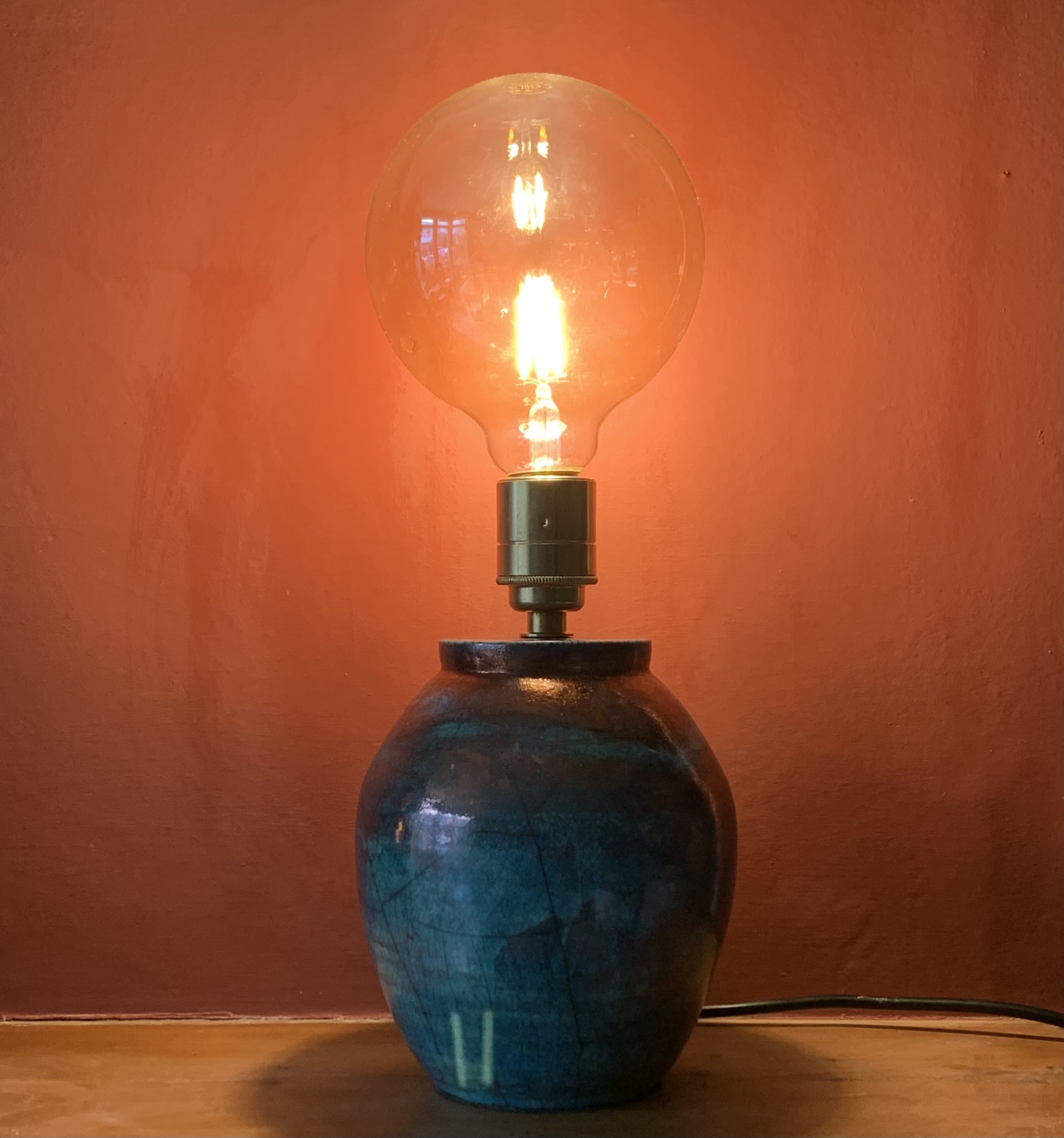 small copper lamp base with edison bulb
